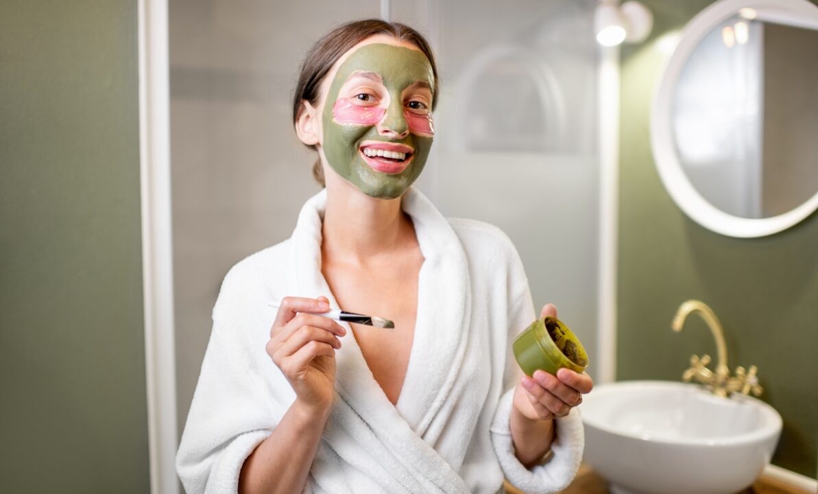 Woman with facial mask and patches in the bathroom