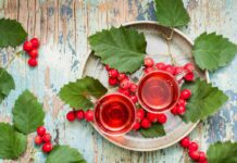 Hot tea from hawthorn berries in transparent glasses on a wooden